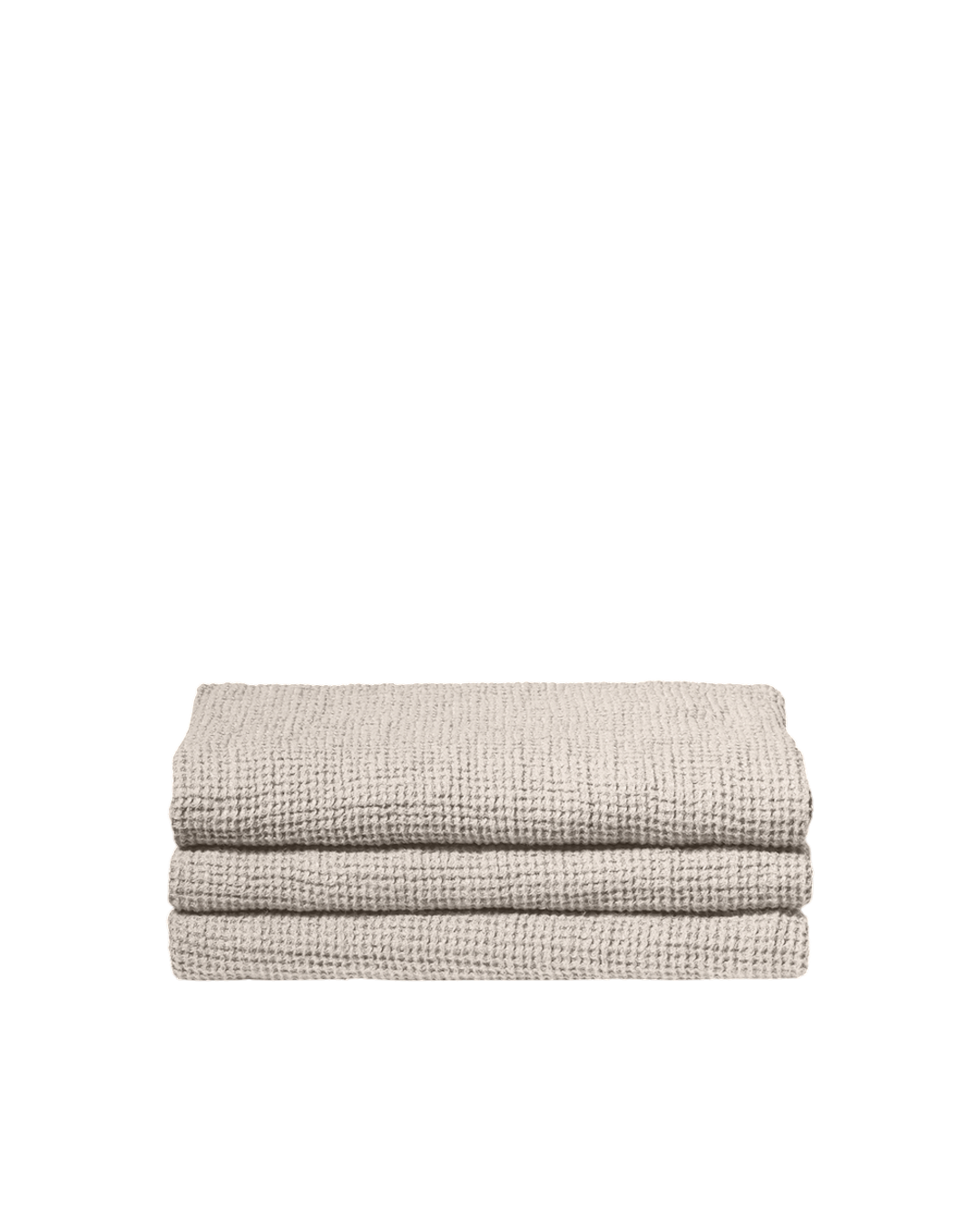 Serviette de bain Merci Paris en lin gaufré couleur pierre, texture moelleuse et absorbante pliée sur fond noir