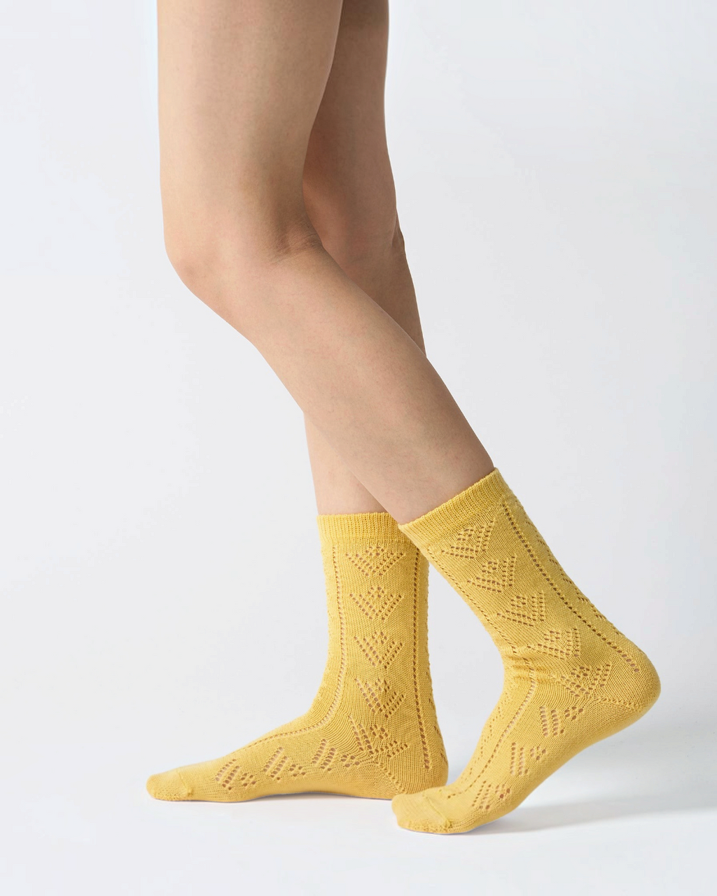 Babaco yellow eyelet socks in wool worn, feminine and artisanal style, available at Merci Paris