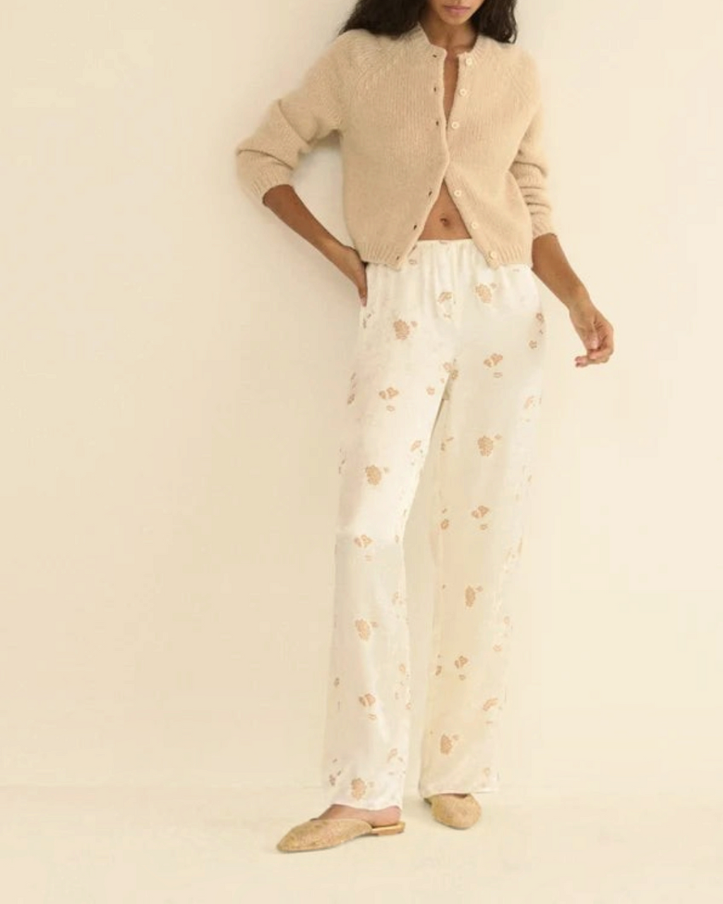 Beige Darcy cardigan in wool and cashmere Merci Paris worn by a woman with flowing patterned pants