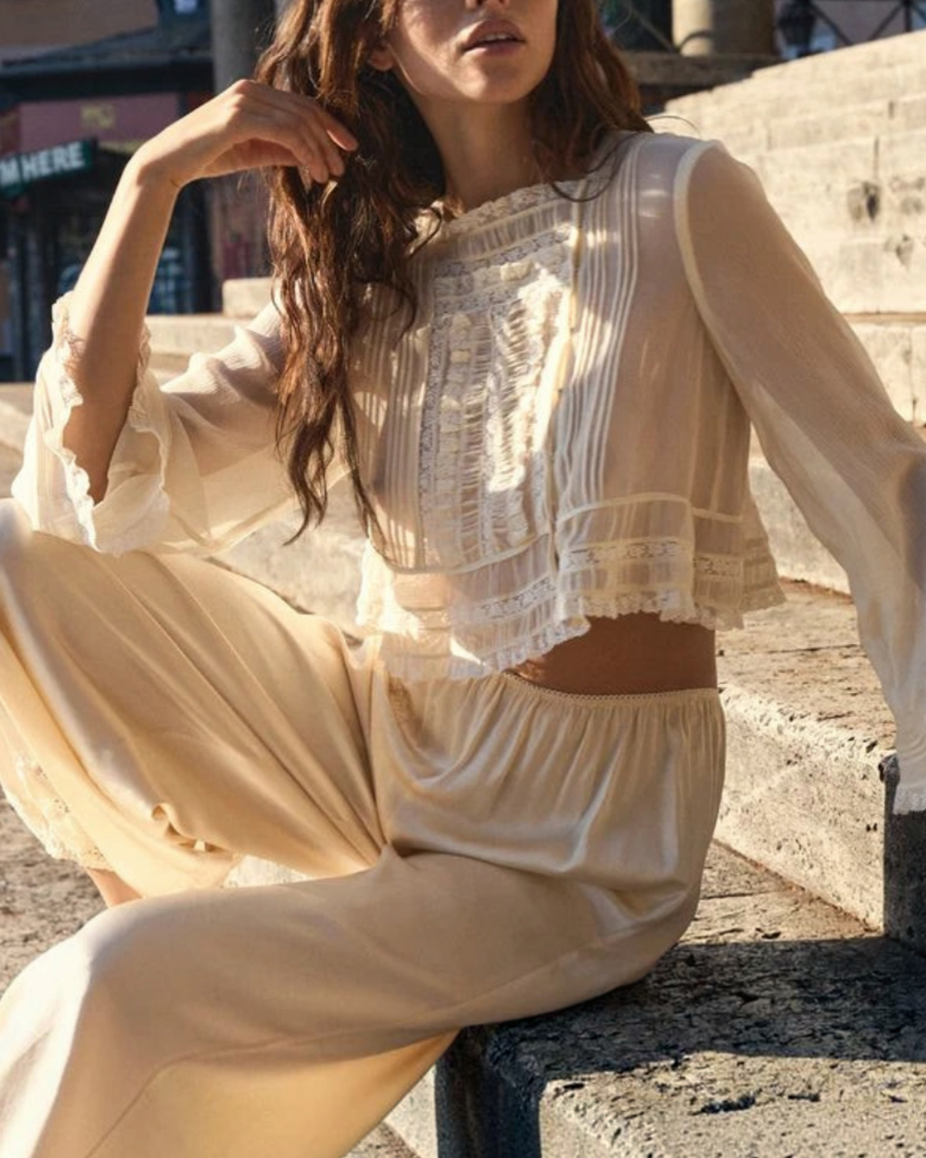 Model wearing the Elodine blouse Merci Paris in ecru silk with lace, square neckline and flared sleeves