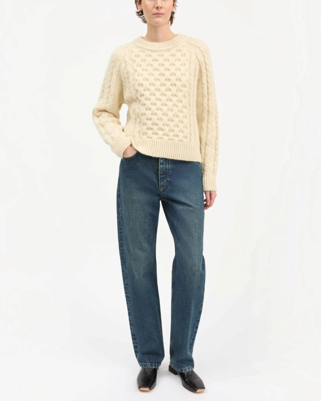 White Lennox sweater in cable knit wool Merci Paris worn by a woman with jeans bleu