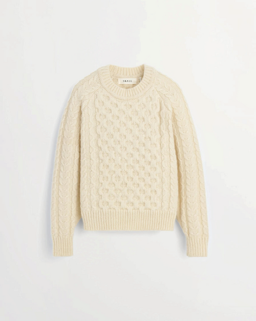 White Lennox sweater in cable knit wool from the brand Merci Paris, with raglan sleeves and round neck.