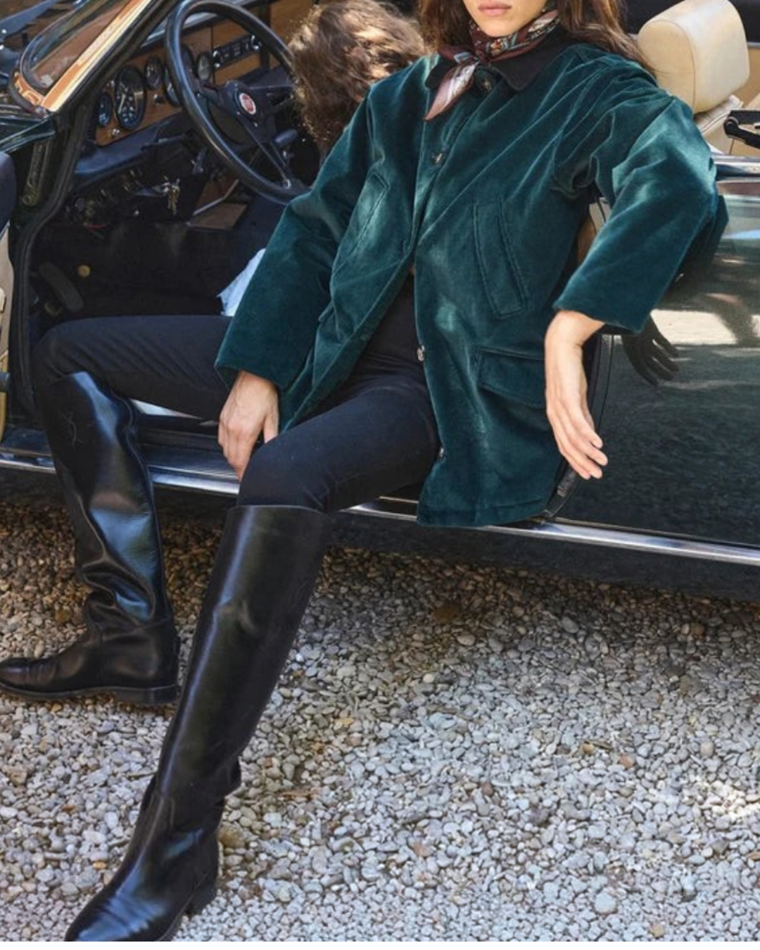Woman wearing Pemberton jacket Merci Paris in green corduroy with suede collar, seated in a convertible car