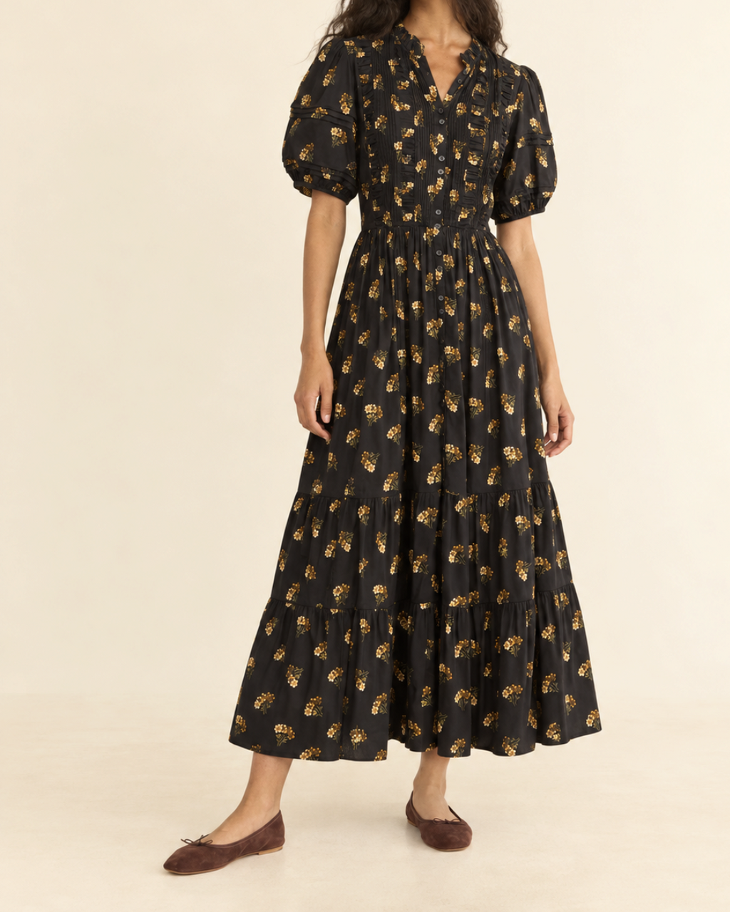 Model wearing the Merci Paris Dôen Haleigh black floral print midi dress, puffed sleeves and ruffled skirt