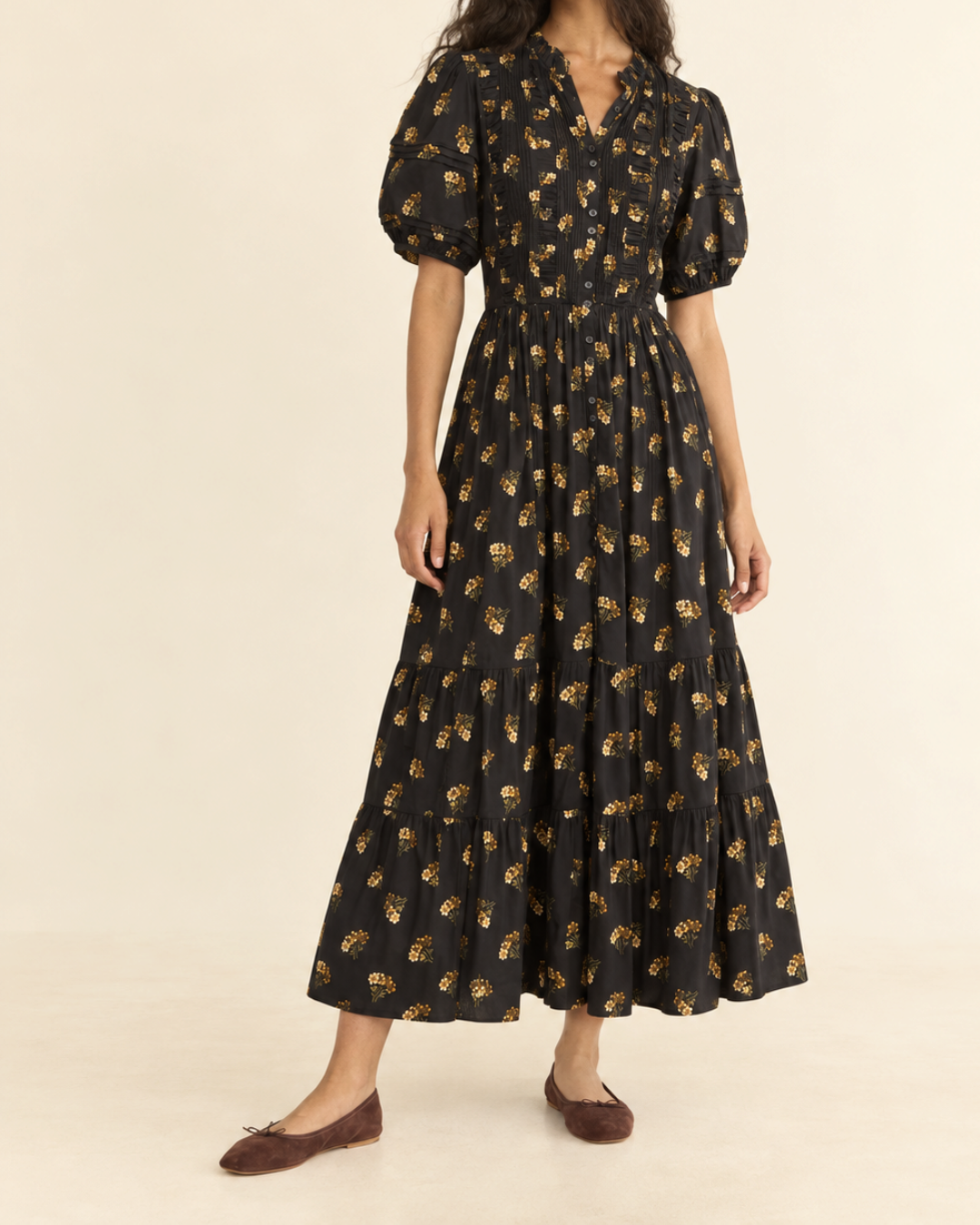Model wearing the Merci Paris Dôen Haleigh black floral print midi dress, puffed sleeves and ruffled skirt