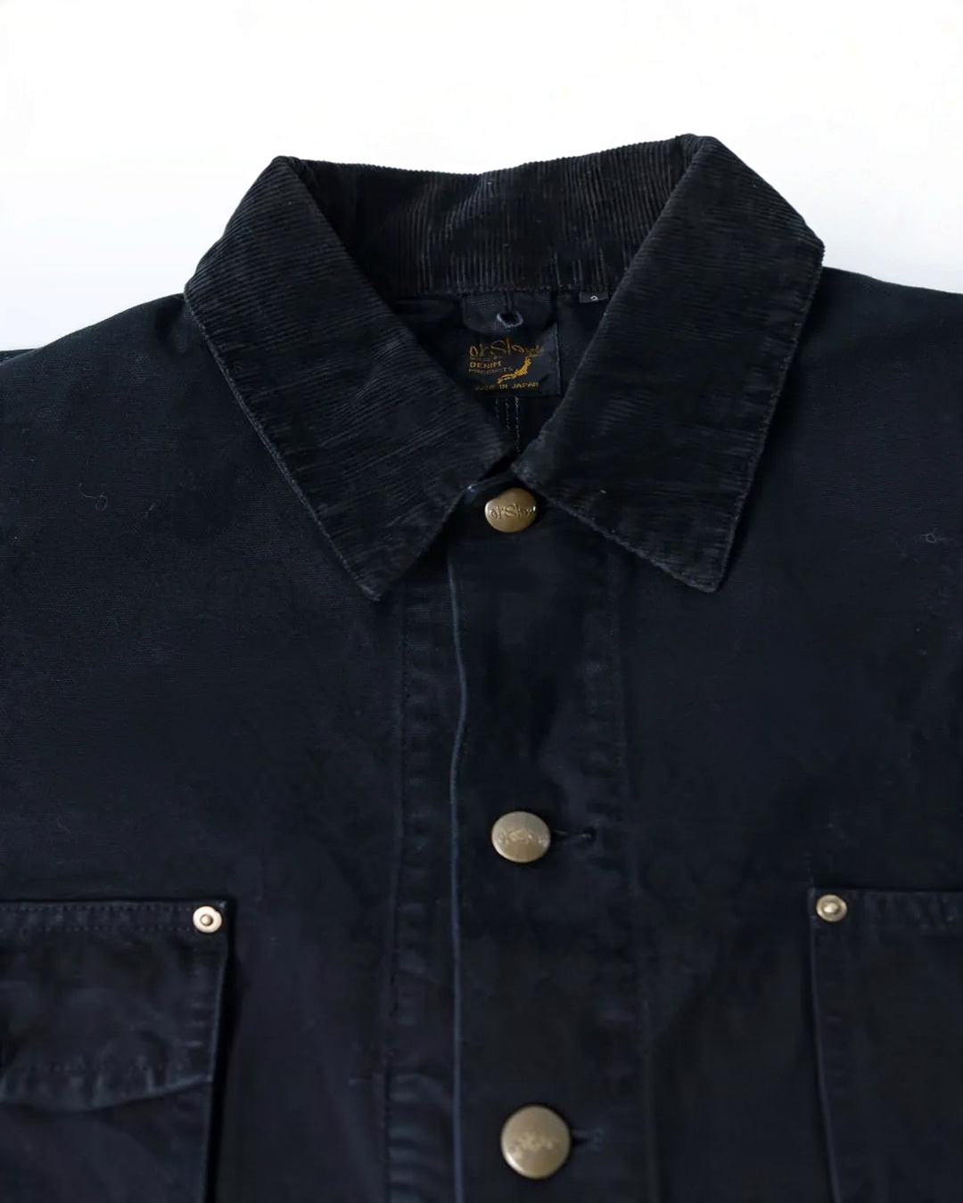 Veste de travail Merci Paris OrSlow en toile de coton noire avec col en velours côtelé et boutons métalliques